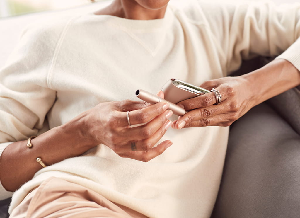 Woman Holding IQOS 3 with Charger