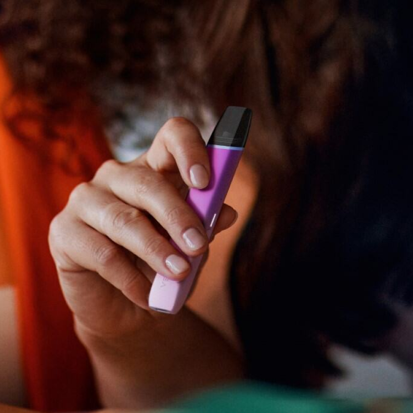 Person holding a VEEV device.