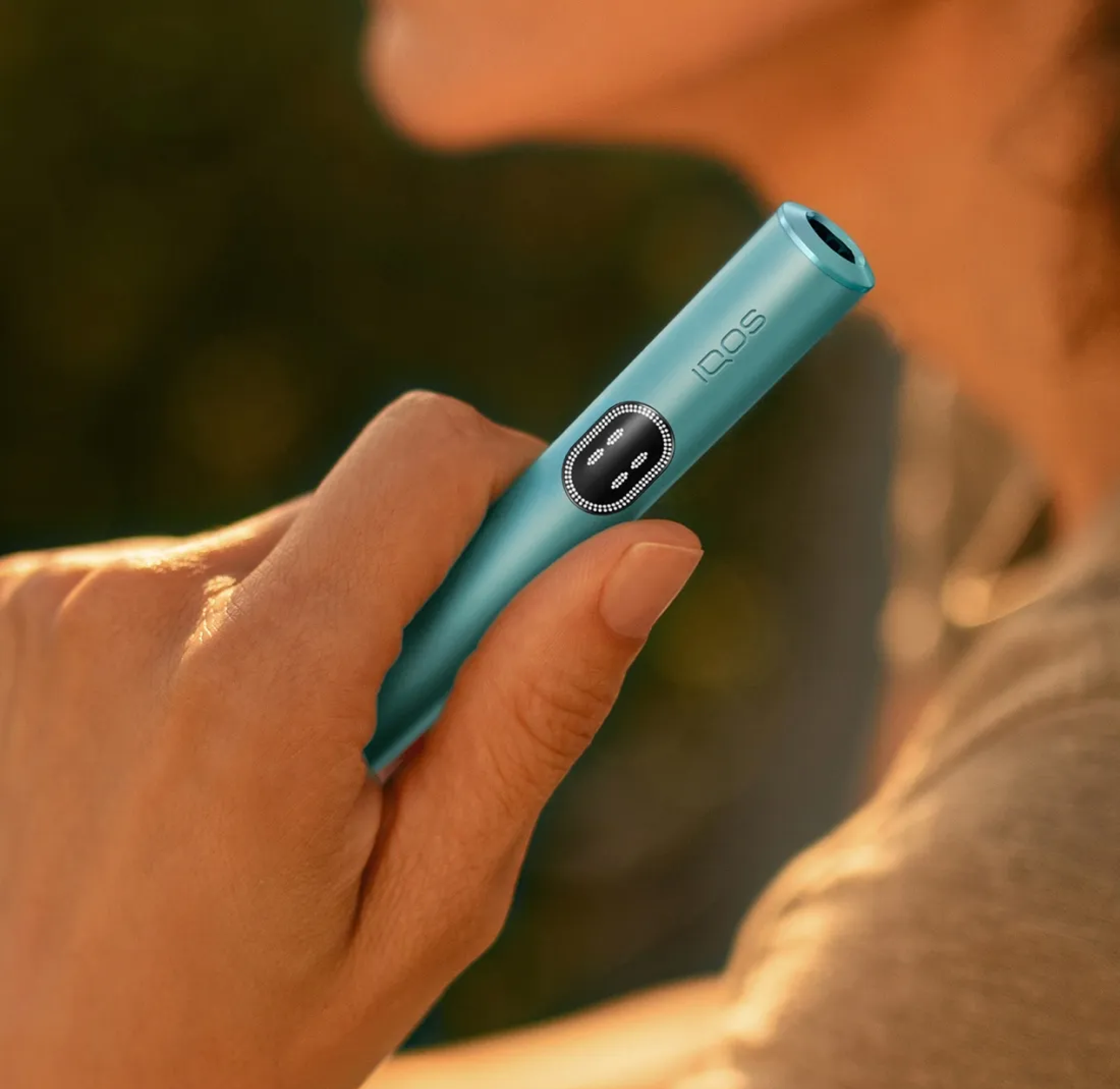 Γυναικείο χέρι κρατάει μια συσκευή IQOS ILUMA i.