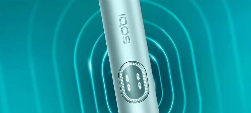 Breeze Blue IQOS ILUMA i PRIME up close, in blue, wavy background.