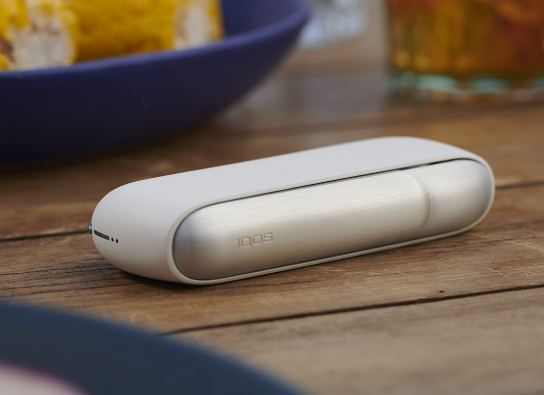 Woman Holding IQOS 3 with Charger