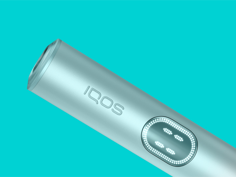 Blue IQOS ILUMA i PRIME device on a light turquoise background