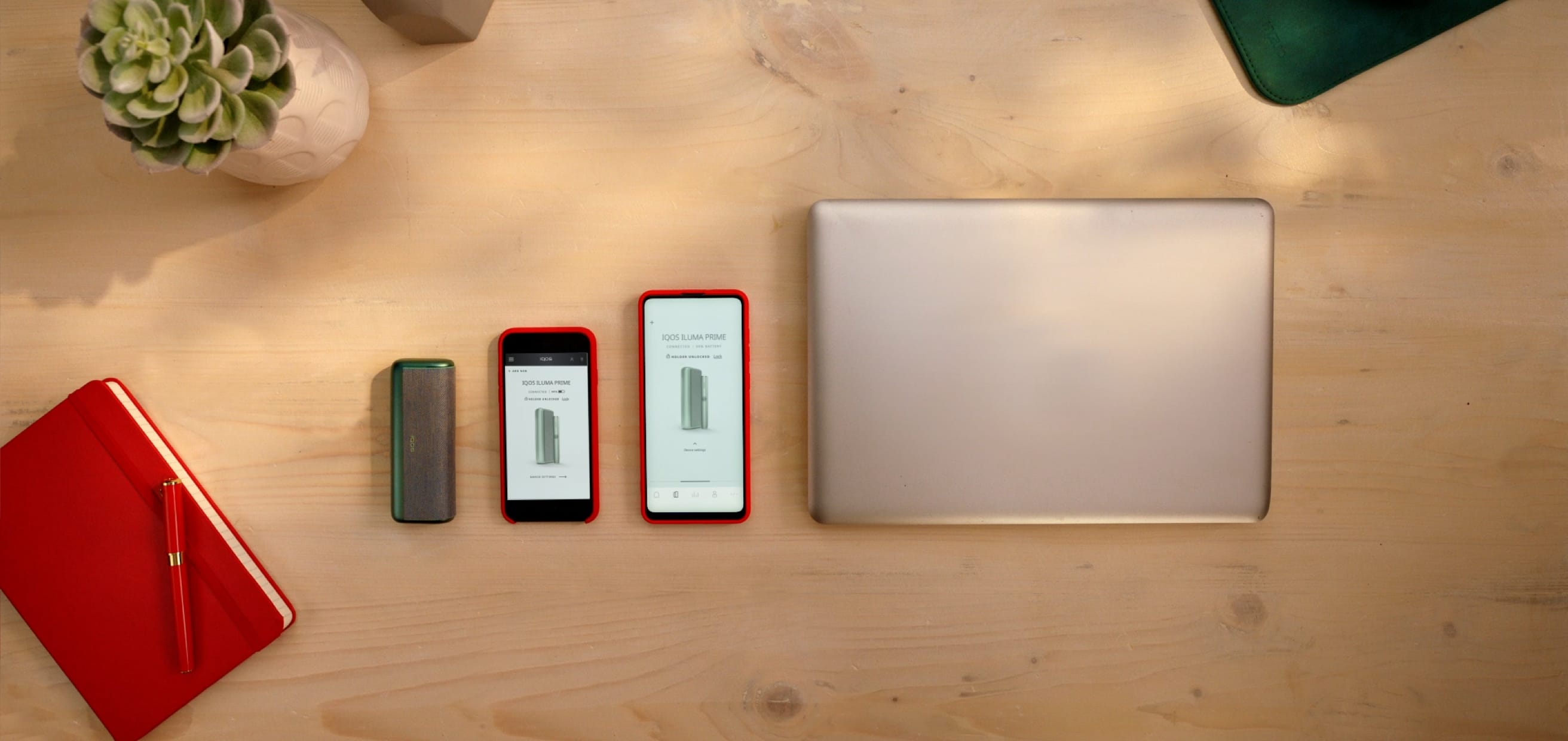 Iluma device, mobile phones and a laptop on the table