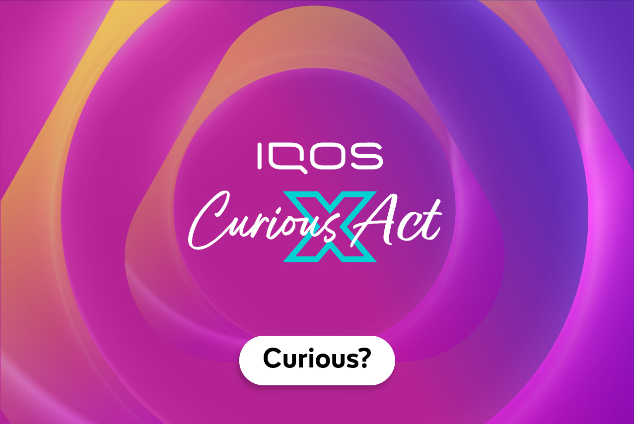 Women looking at an IQOS device