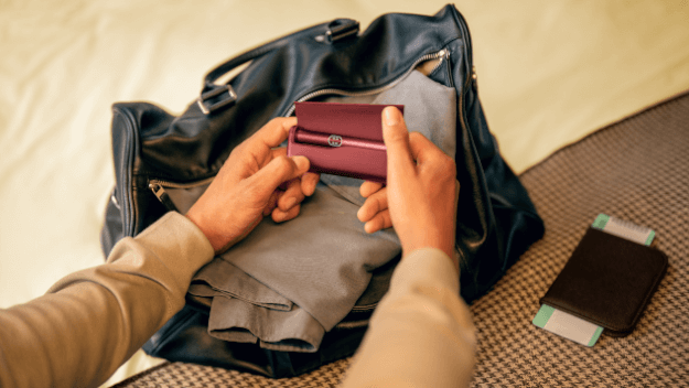 Hands holding smartphones and one IQOS device.