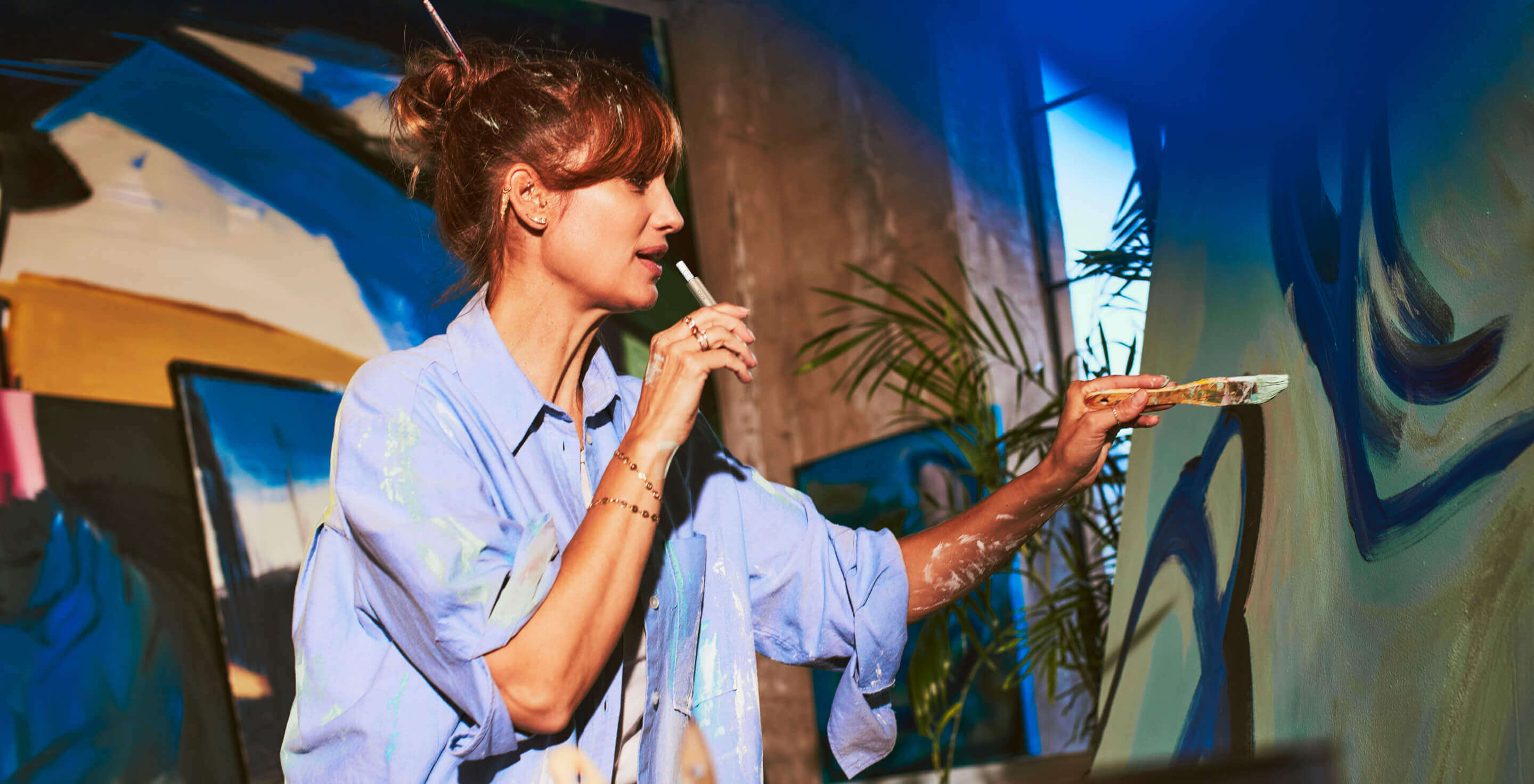 An artist using her IQOS ILUMA device.